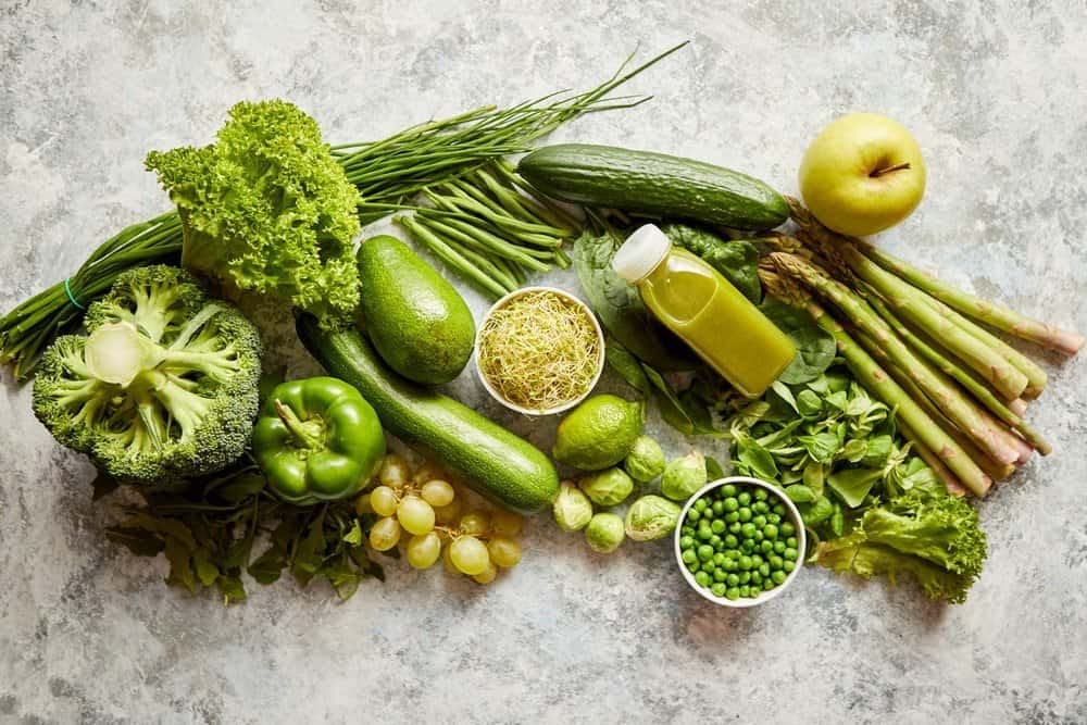 Green antioxidant organic vegetables, fruits and herbs placed on gray stone table. Top view with copy space. - A Natural Way to Detox Your Body