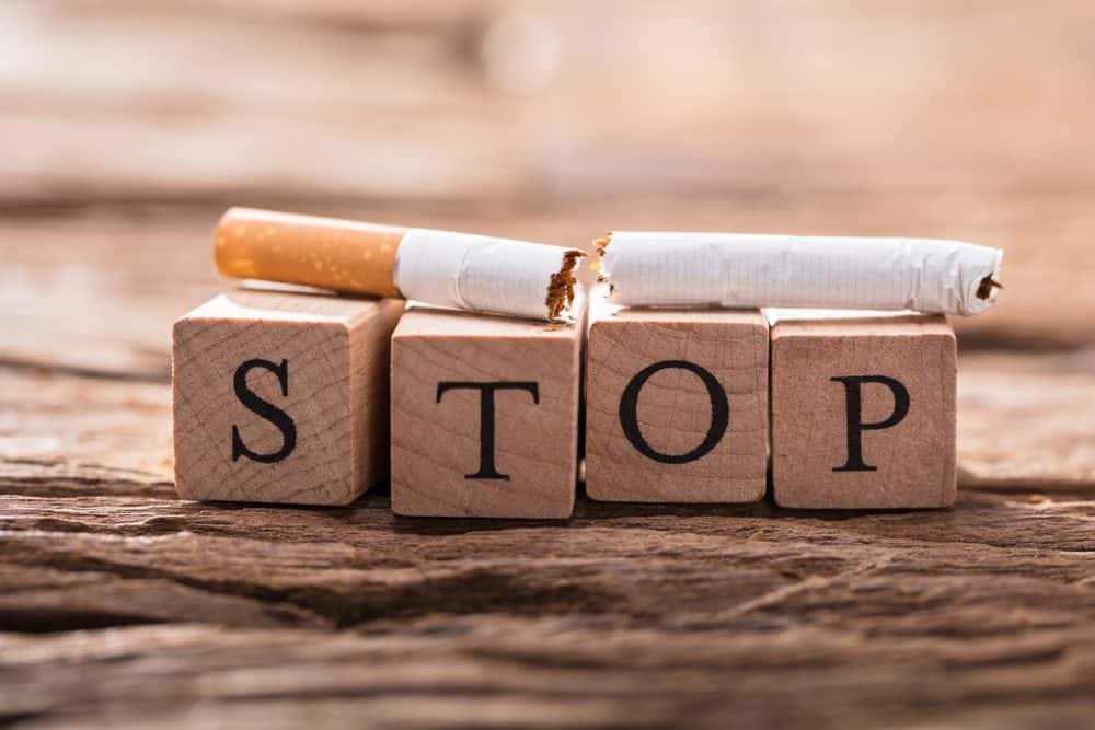A Cigarette And Wooden Blocks Showing Stop Word On Desk - 10 Ways to Lose Belly Fat