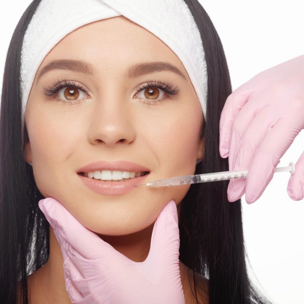 A pretty girl is doing botox injections to reverse skin aging