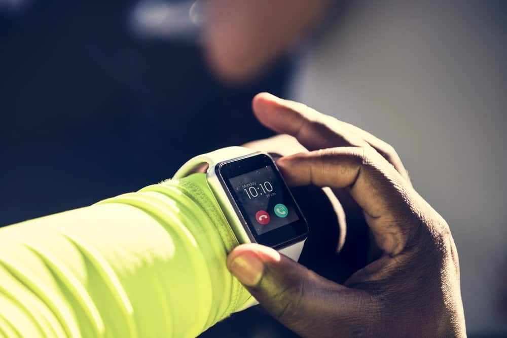 Closeup of smartwatch on a wrist - Closeup of mockup smartwatch isolated on whtie background - people, bedtime and rest concept - Benefits in Wearable Technology