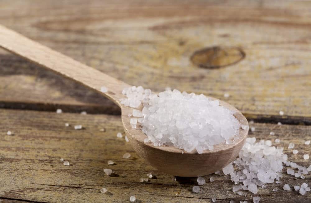 Old Brown wood spoon with salt cristals on wood table - A Natural Way to Detox Your Body