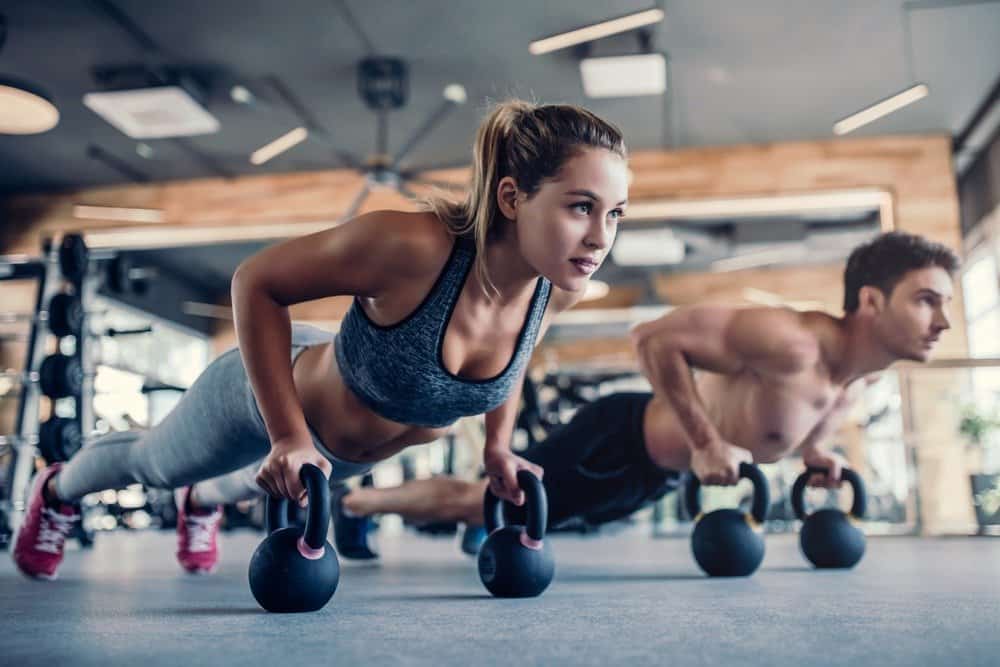 Young couple is working out at gym - Habits of Super Healthy People