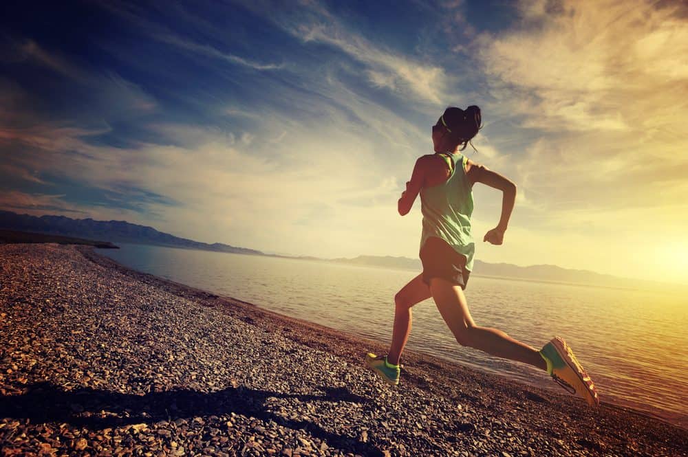 young woman running on seaside - How to avoid the risks of Running as a beginner and boost your body