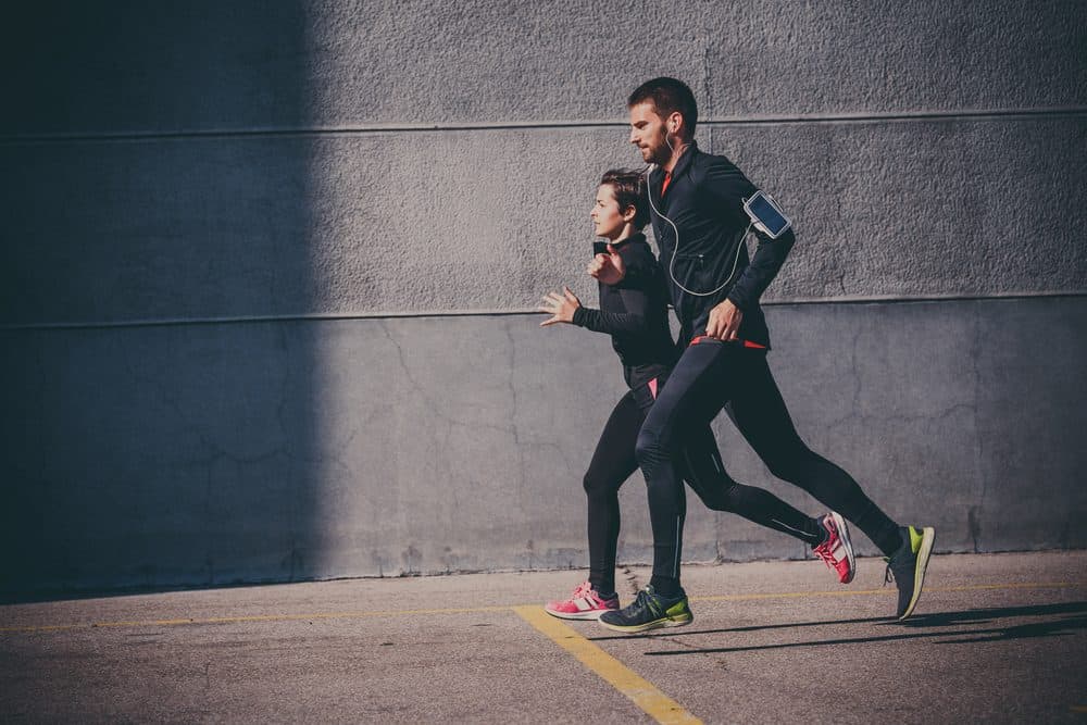 Couple running in an urban area - How Frequently Should a Beginner Exercise Running to Achieve Best Results for the Body and Avoid Injuries Explained