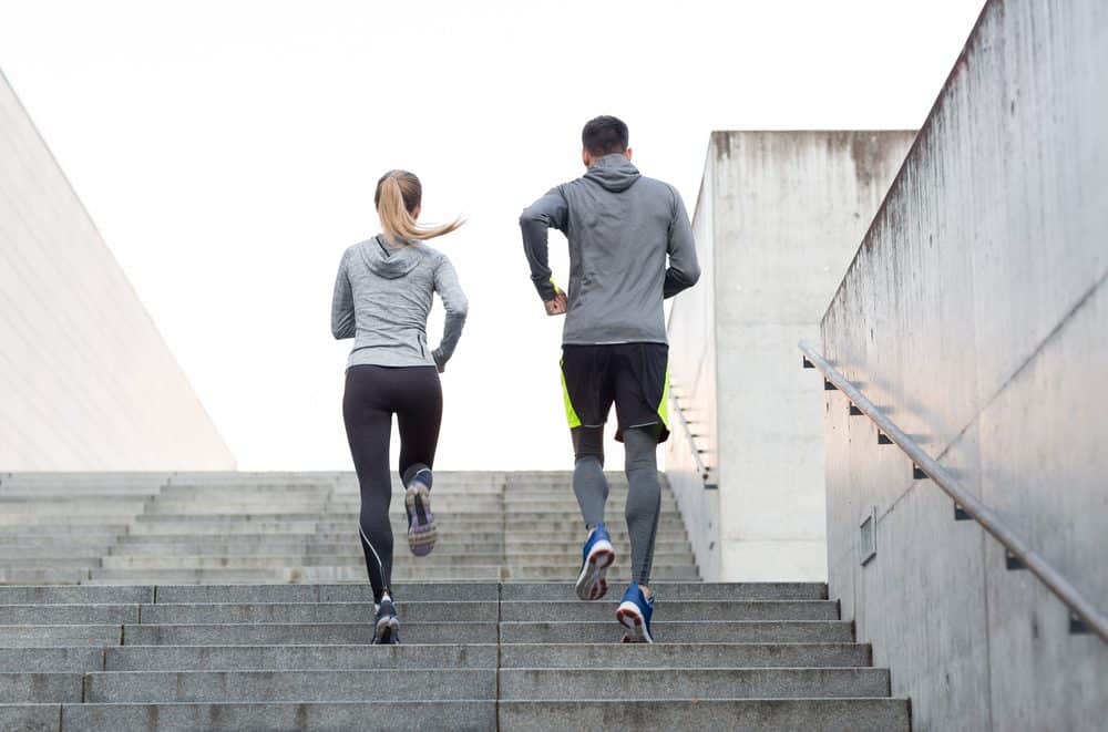 Couple running on city stairs - How Frequently Should a Beginner Exercise Running to Achieve Best Results for the Body and Avoid Injuries Explained