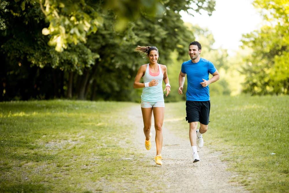 Young happy couple running - How Frequently Should a Beginner Exercise Running to Achieve Best Results for the Body and Avoid Injuries Explained