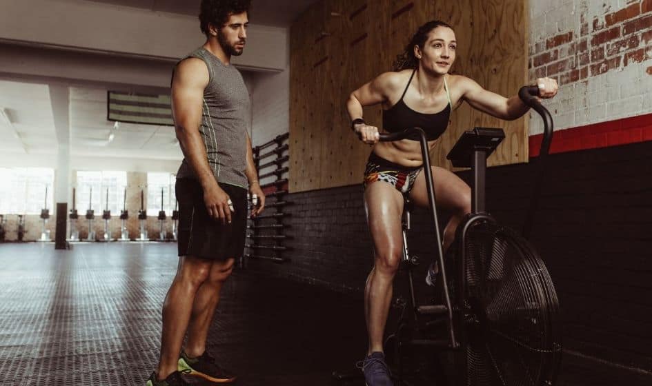 A woman exercising in a elliptical machine 