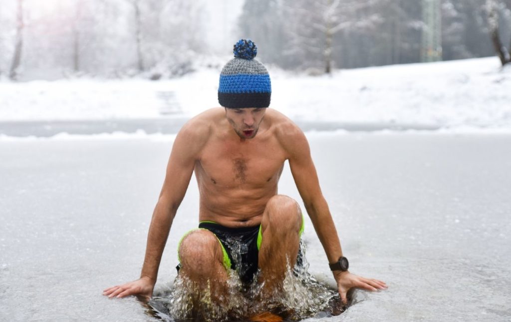 A man is taking a bath in freezing waters