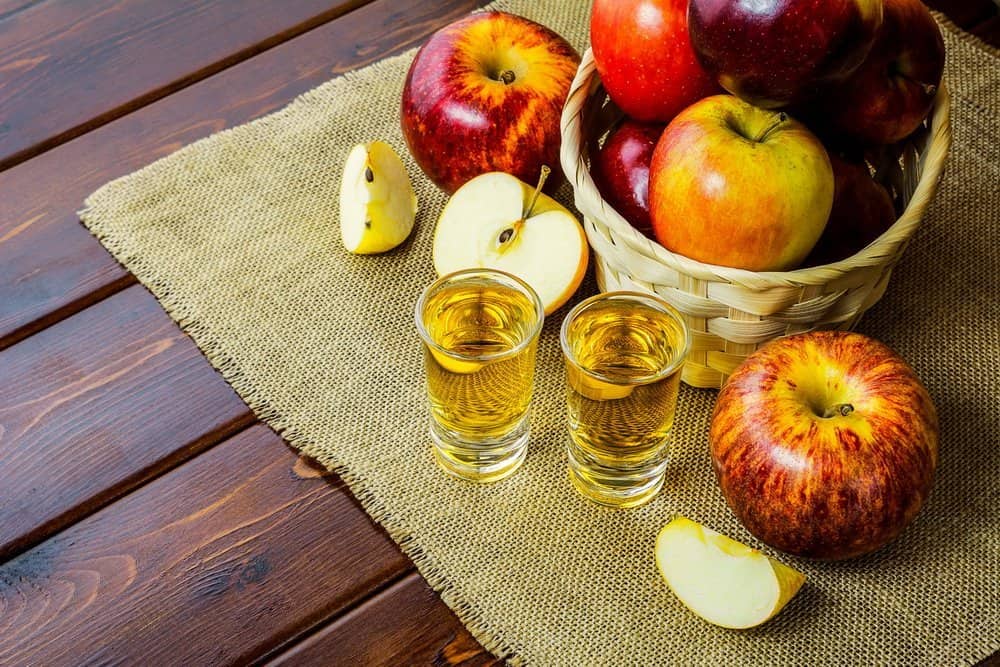 Apple brandy shots and red apples