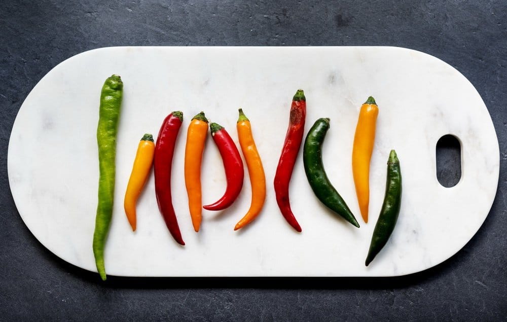 Aerial view of cayenne chili peppers on cutboard - Diet Smoothies for Weight Loss