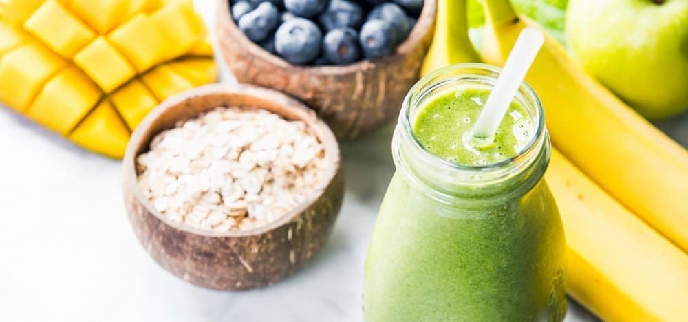 Close-up of green fresh smoothie with fruits, berries, oats and seeds, selective focus. Detox, dieting, clean eating, vegetarian, vegan, fitness, healthy lifestyle concept - Diet Smoothies for Weight Loss