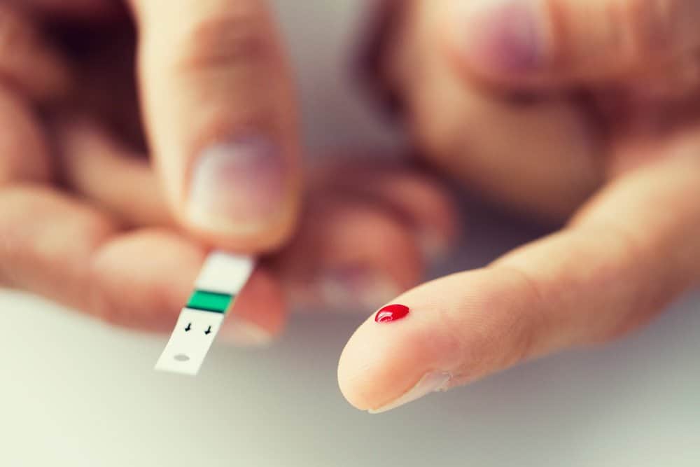 medicine, diabetes, glycemia, health care and people concept - close up of male finger with blood drop and test stripe - Side Effects from Keto Diet