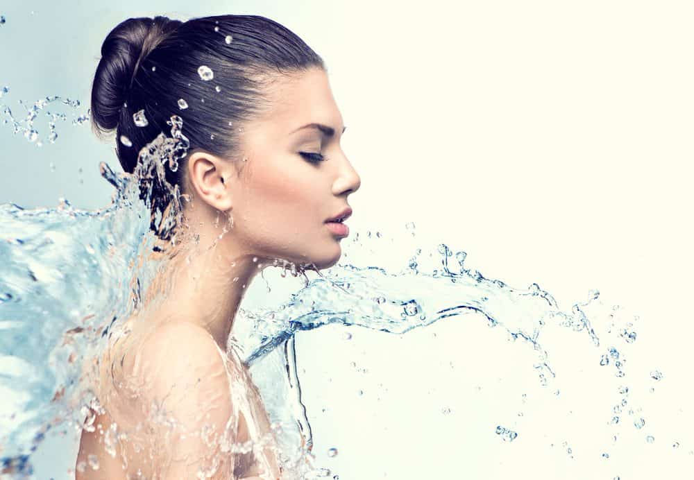Beautiful Model Woman with splashes of water in her hands - 10 Reasons why Water is Important
