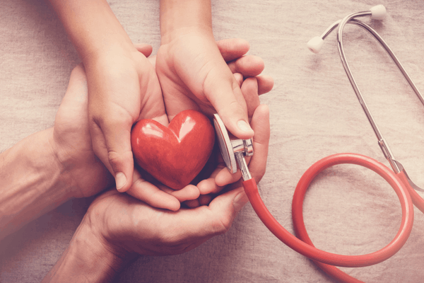 Blood pressure -child and adult holding red heart with stethoscope, heart health, health insurance concept, world health day1