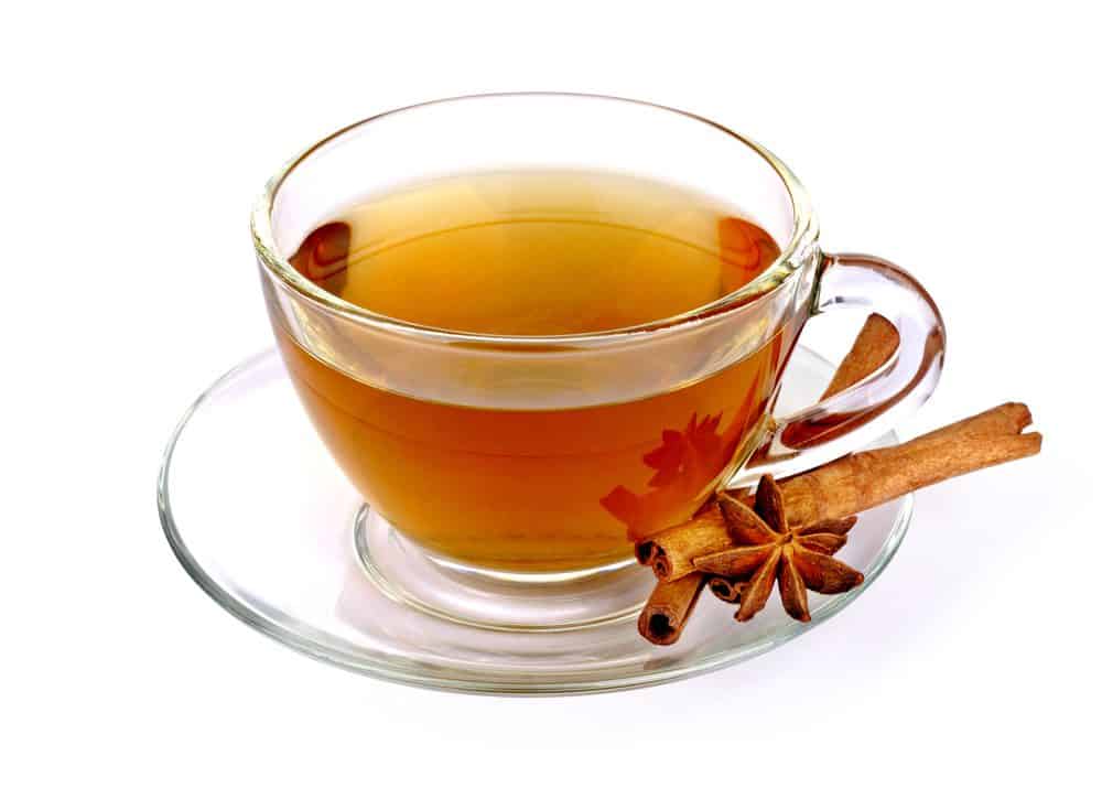 Glass cup of green tea with cinnamon sticks - Lose Weight Naturally Fast