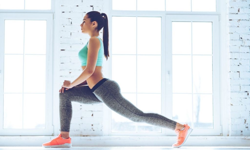 A girl is doing a warm up session in order to Stay Active During Coronavirus - Health and Fitness Tips