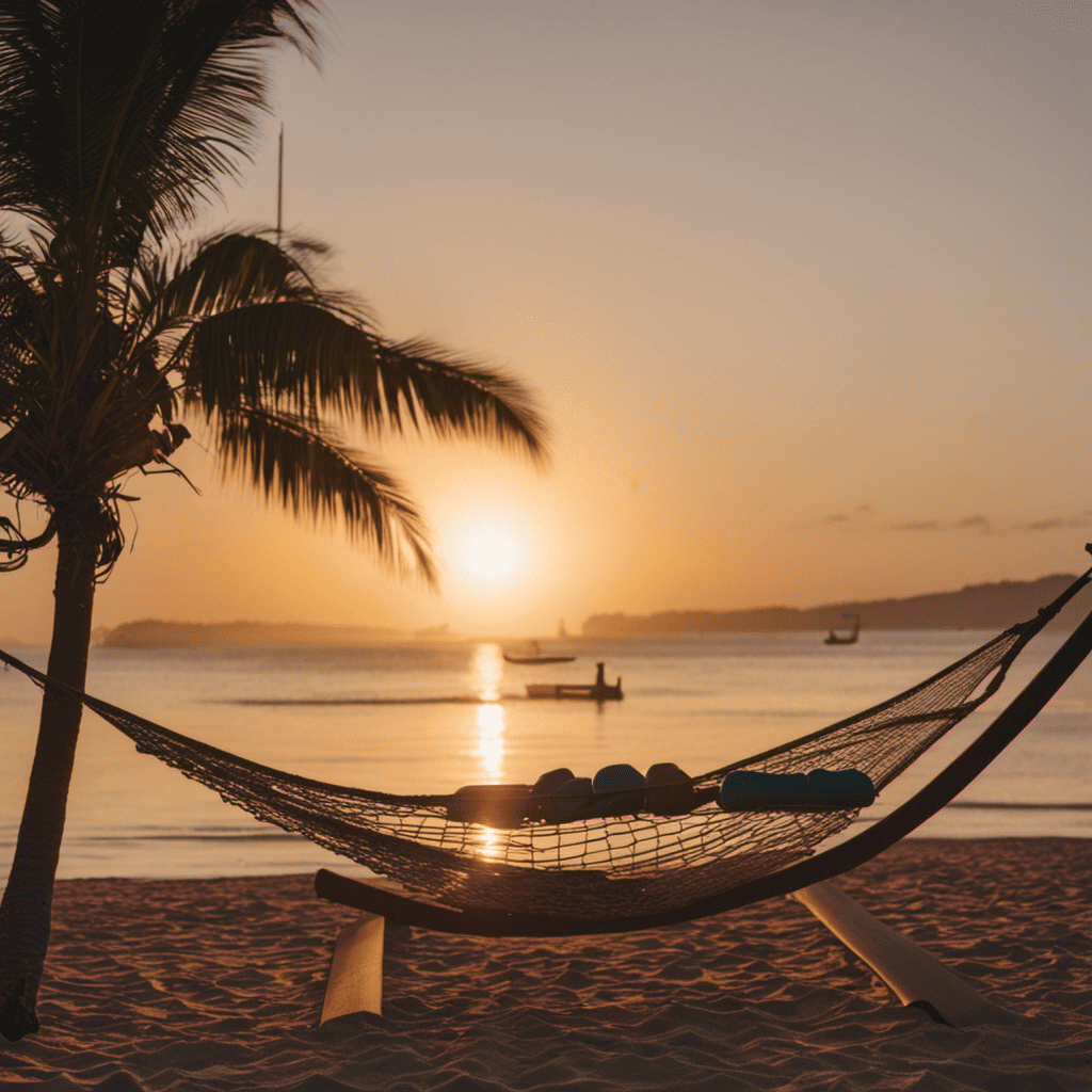 An image of a serene sunset beach, with a lone figure lying on a hammock beneath a palm tree, surrounded by scattered dumbbells and a yoga mat, inviting readers to embrace the rejuvenating power of rest days