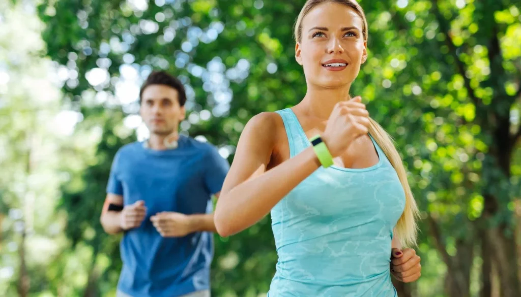 A woman and a man running in a park - In order to Maintaining a Healthy Metabolic Age you must Stay physically active