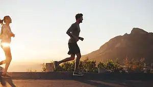 Trail runner on a rocky path, highlighting potential risks and injuries for beginner runners, promoting safety and awareness.