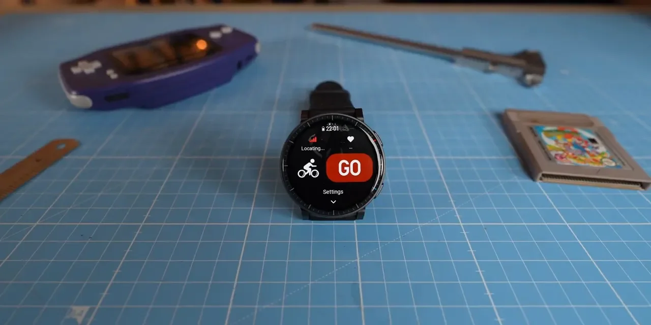 Amazfit Active Max front-facing on a desk showing 'GO' workout screen and locating GPS