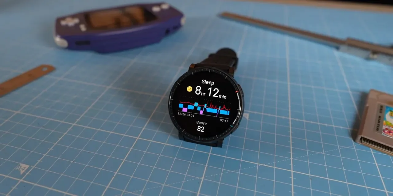 Amazfit Active Max close-up on a cutting mat showing sleep score and stage graph on the watch display